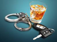 Drunk driving elements: car keys, handcuffs and alcoholic drink.