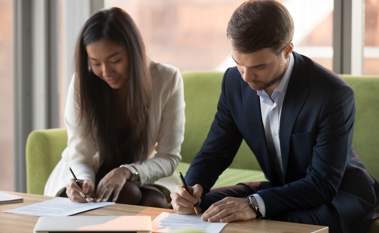 husband and wife signing divorce papers without court