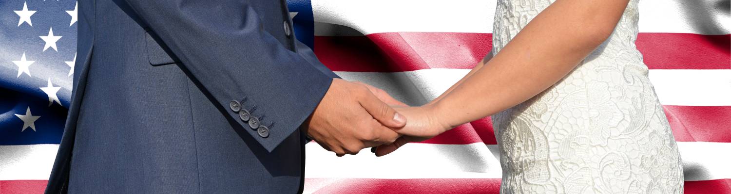 Husband and immigrant wife in front of US flag