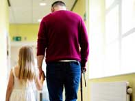 Disabled man walks with child